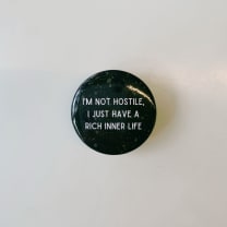 I'm Not Hostile I Just Have a Rich Inner Life 1.5" Button in Black and Tan