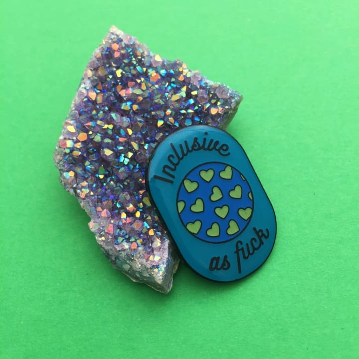 Inclusive As Fuck Oval Enamel Pin In Blue Earth