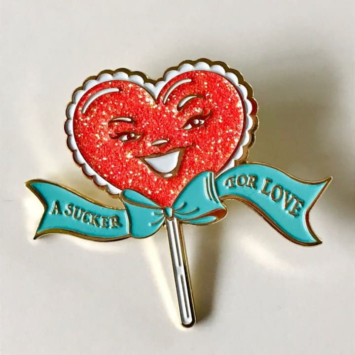 A Sucker For Love Soft Enamel Pin | Heart-Shaped Lollipop with Red Glitter