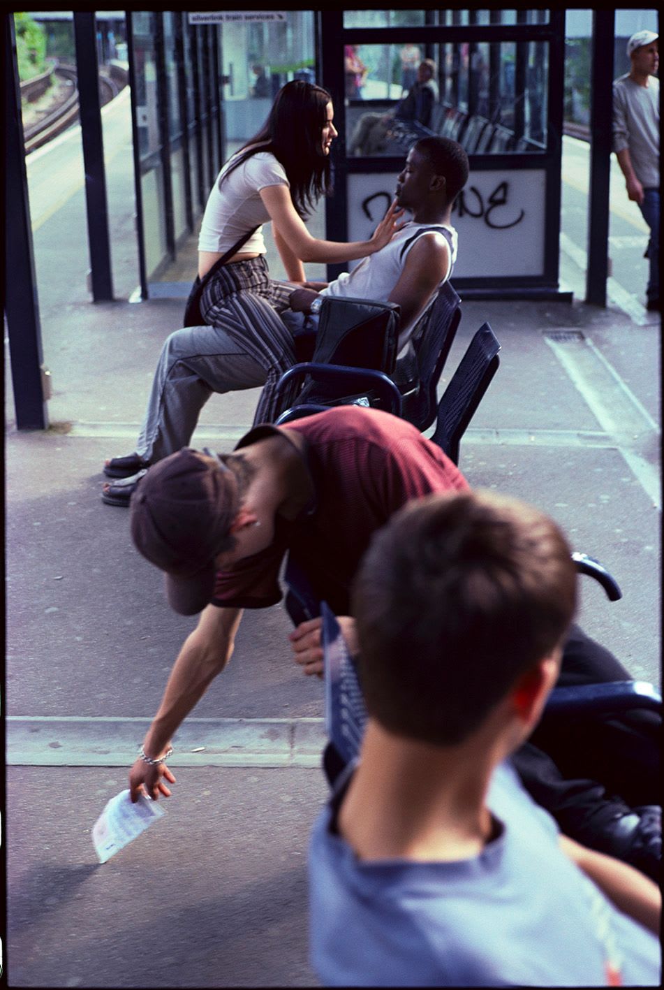 Image of teens on a train platform by Simon Wheatley