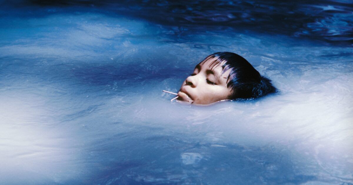 Image of indigenous person submerged in blue water for 'The Yanomami Struggle' exhibition