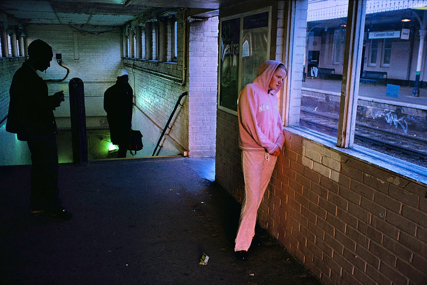Young girl in tracksuit at the train station - Simon Wheatley