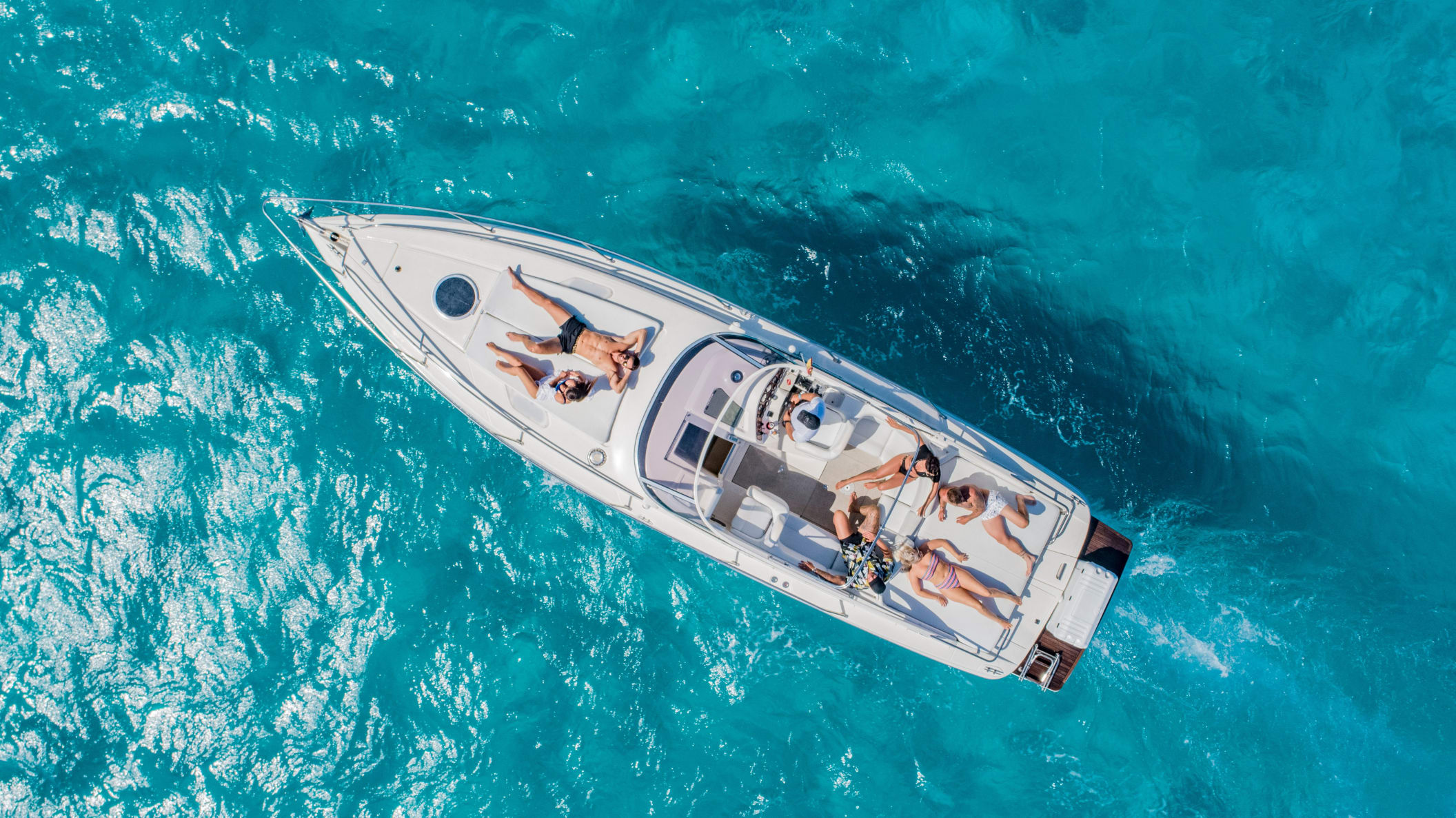 People relaxing on boat in Ibiza